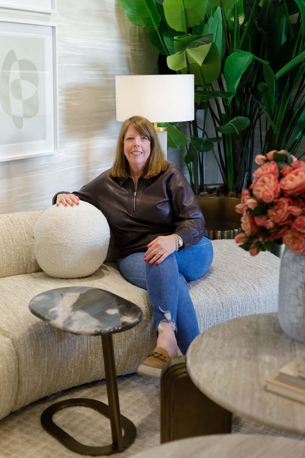 Shelley, founder of The Open Door Style & Design, seated in a styled living room