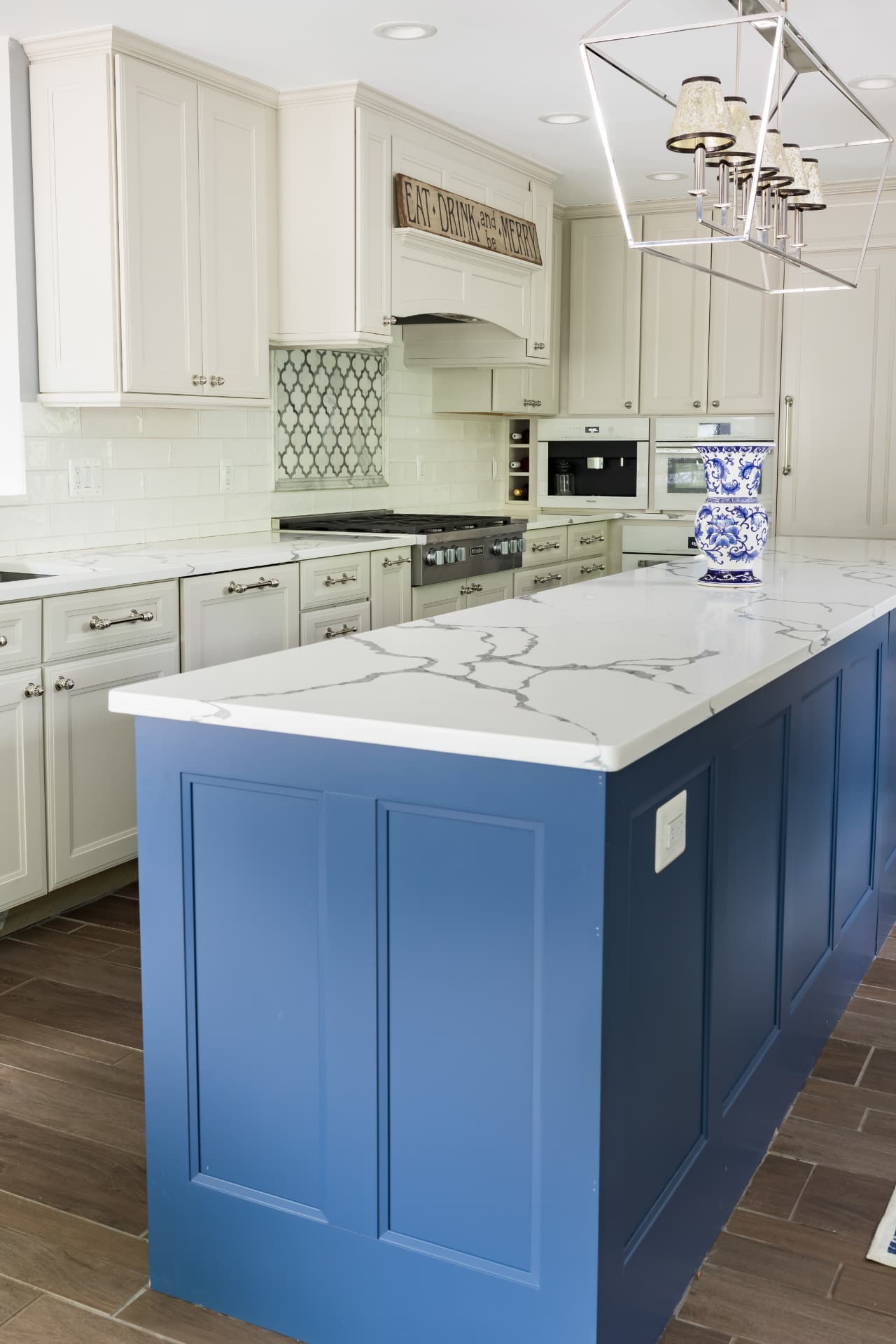 Custom navy and cream kitchen with quartz counters and polished nickel hardware